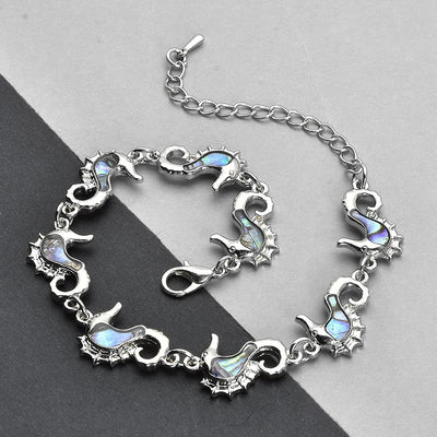 The Tropicana Mo'o Lio Seahorse Bracelet - A beautiful silver seahorse bracelet adorned with lovely polished paua shell.