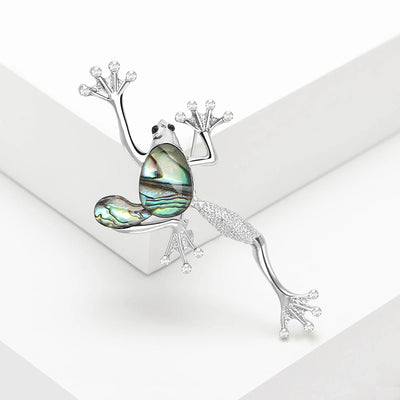 The Tropicana Poloka Frog Brooch - A beautiful silver-toned zinc alloy frog brooch adorned with crystals and polished paua shell.