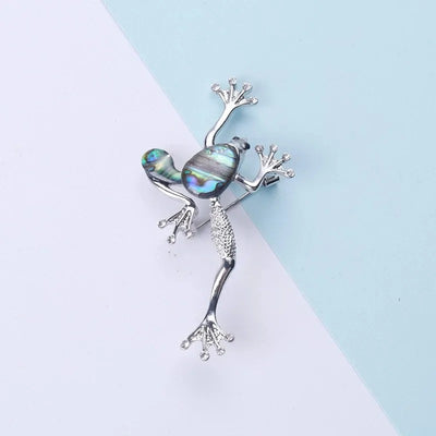 The Tropicana Poloka Frog Brooch - A beautiful silver-toned zinc alloy frog brooch adorned with crystals and polished paua shell.