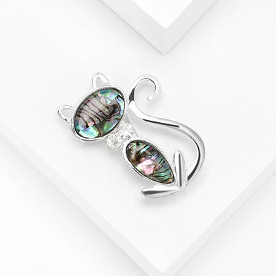 The Tropicana Popoki Cat Brooch - A stylised silver-toned zinc alloy cat brooch adorned with polished paua shell and artificial crystals.
