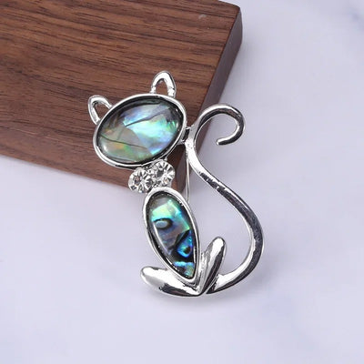 The Tropicana Popoki Cat Brooch - A stylised silver-toned zinc alloy cat brooch adorned with polished paua shell and artificial crystals.
