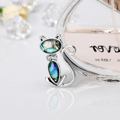 The Tropicana Popoki Cat Brooch - A stylised silver-toned zinc alloy cat brooch adorned with polished paua shell and artificial crystals.