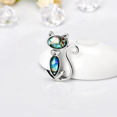 The Tropicana Popoki Cat Brooch - A stylised silver-toned zinc alloy cat brooch adorned with polished paua shell and artificial crystals.