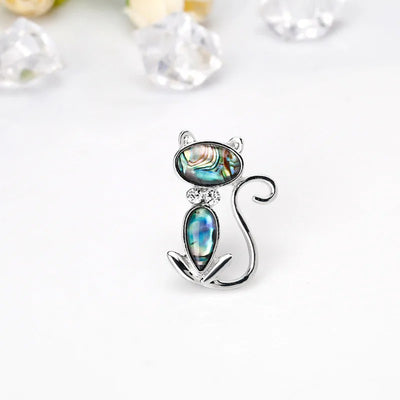 The Tropicana Popoki Cat Brooch - A stylised silver-toned zinc alloy cat brooch adorned with polished paua shell and artificial crystals.