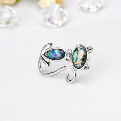 The Tropicana Popoki Cat Brooch - A stylised silver-toned zinc alloy cat brooch adorned with polished paua shell and artificial crystals.
