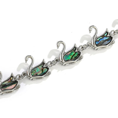 The Tropicana Ululani Swan Bracelet - A beautiful silver swan bracelet adorned with lovely polished paua shell.