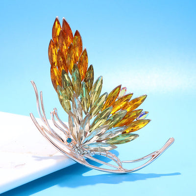 Tulia Oversized Butterfly Brooch - A huge crystal brooch featuring a side-view of a butterfly with a gradient of crystals making up its wings, available in blue, green, reddish pink, or yellow colour palettes.