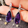 Verona Teardrop Crystal Drop Earrings - Elegant, classic drop earrings featuring a large purple central stone surrounded by tiny white quartz.