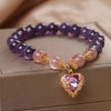 Violette Amethyst Stretch Bracelet - An elegant bracelet made from round purple and pink beads with a heart-shaped topaz as the centre piece.