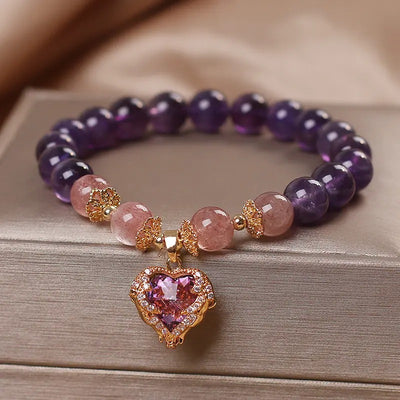 Violette Amethyst Stretch Bracelet - An elegant bracelet made from round purple and pink beads with a heart-shaped topaz as the centre piece.