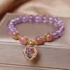 Violette Amethyst Stretch Bracelet - An elegant bracelet made from round purple and pink beads with a heart-shaped topaz as the centre piece.