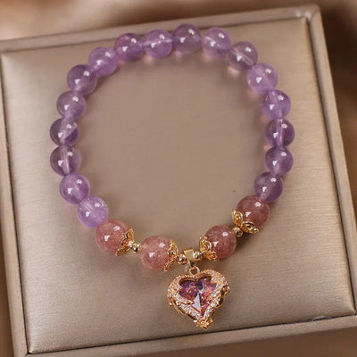 Violette Amethyst Stretch Bracelet - An elegant bracelet made from round purple and pink beads with a heart-shaped topaz as the centre piece.