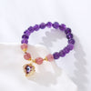 Violette Amethyst Stretch Bracelet - An elegant bracelet made from round purple and pink beads with a heart-shaped topaz as the centre piece.