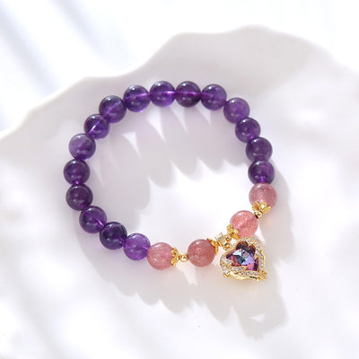 Violette Amethyst Stretch Bracelet - An elegant bracelet made from round purple and pink beads with a heart-shaped topaz as the centre piece.