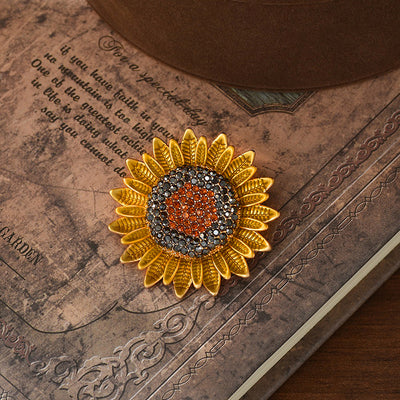 The Elidi Sunflower Brooch. This beautiful brooch is a simple, but elegant classical stylised sunflower, with glossy yellow petals, and sparkling crystals around the inside of the blossom.