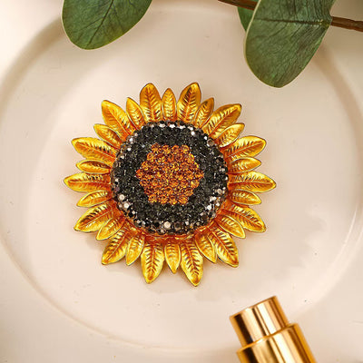 The Elidi Sunflower Brooch. This beautiful brooch is a simple, but elegant classical stylised sunflower, with glossy yellow petals, and sparkling crystals around the inside of the blossom.