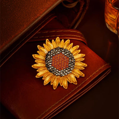 The Elidi Sunflower Brooch. This beautiful brooch is a simple, but elegant classical stylised sunflower, with glossy yellow petals, and sparkling crystals around the inside of the blossom.