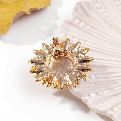 The Elidi Sunflower Brooch. This beautiful brooch is a simple, but elegant classical stylised sunflower, with glossy yellow petals, and sparkling crystals around the inside of the blossom.