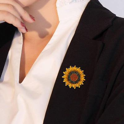 The Elidi Sunflower Brooch. This beautiful brooch is a simple, but elegant classical stylised sunflower, with glossy yellow petals, and sparkling crystals around the inside of the blossom.