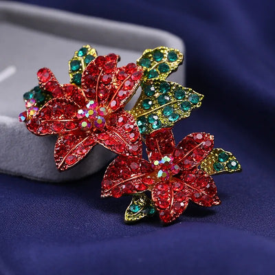 Poinsettia Sparkle Crystal Brooch - A large pave-style brooch shaped like a pair of lovely red poinsettia blossoms flanked by green leaves.