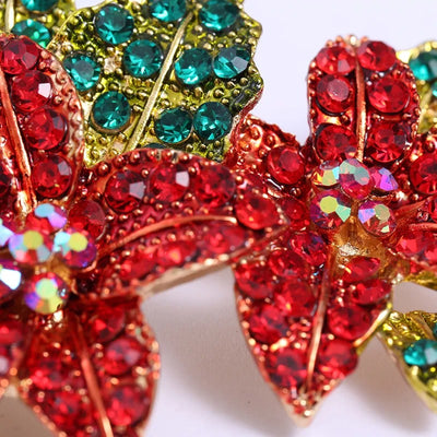 Poinsettia Sparkle Crystal Brooch - A large pave-style brooch shaped like a pair of lovely red poinsettia blossoms flanked by green leaves.
