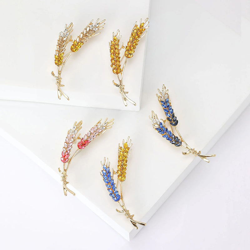 Cailleach Grain Sheath Brooch - An elegant crystal brooch shaped like a pair of wheat stalks bound by a delicate thread.