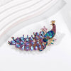 The Juno Crystal Peacock Brooch - A lovely stylized peacock brooch featuring glossy enamel paint and sparkling crystals.