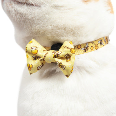 Little Kitty Co. Cat Collar & Bow Tie - Bee-Hiving is a vibrant yellow design featuring an adorable little print of cartoon bumblebees and honey. Buzz buzz, baby!