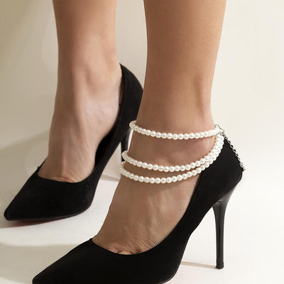 Marlene Pearl Anklet - A simple, elegant, vintage-style anklet featuring three strands of white artificial pearls attached to a lobster clasp at the back.