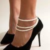 Marlene Pearl Anklet - A simple, elegant, vintage-style anklet featuring three strands of white artificial pearls attached to a lobster clasp at the back.