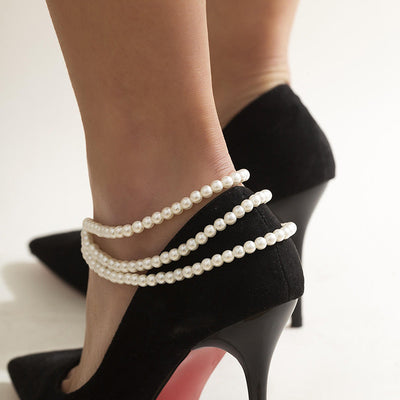 Marlene Pearl Anklet - A simple, elegant, vintage-style anklet featuring three strands of white artificial pearls attached to a lobster clasp at the back.