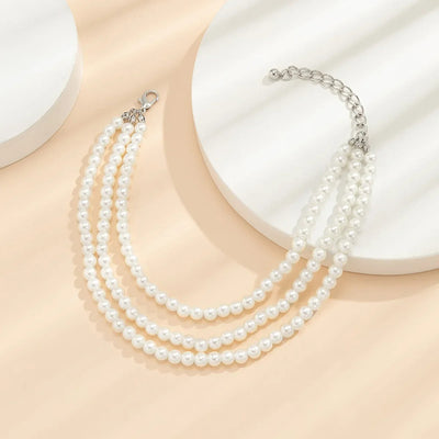 Marlene Pearl Anklet - A simple, elegant, vintage-style anklet featuring three strands of white artificial pearls attached to a lobster clasp at the back.