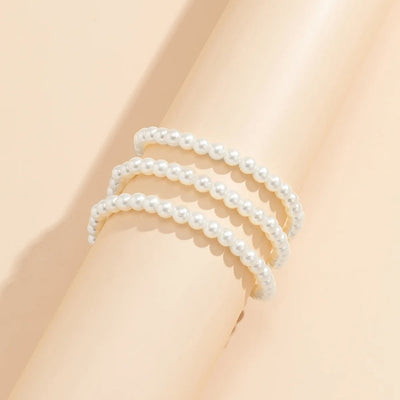 Marlene Pearl Anklet - A simple, elegant, vintage-style anklet featuring three strands of white artificial pearls attached to a lobster clasp at the back.