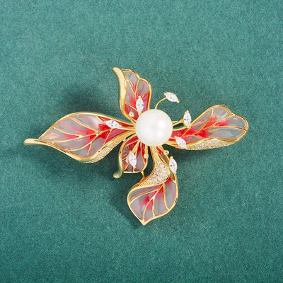 The Lorelei Lily Sculpted Resin Brooch - A lovely, long, elegant piece that features a five-petal lily clustered around a single pearl, with colourful resin to really make it pop and a dusting of crystal along the underside of the petals.