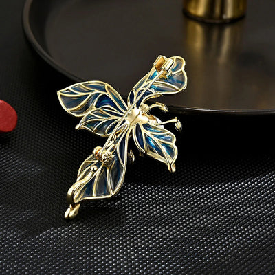 The Lorelei Lily Sculpted Resin Brooch - A lovely, long, elegant piece that features a five-petal lily clustered around a single pearl, with colourful resin to really make it pop and a dusting of crystal along the underside of the petals.