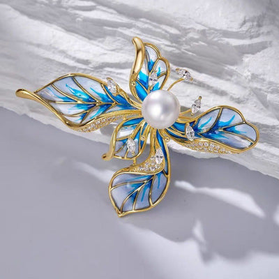 The Lorelei Lily Sculpted Resin Brooch - A lovely, long, elegant piece that features a five-petal lily clustered around a single pearl, with colourful resin to really make it pop and a dusting of crystal along the underside of the petals.