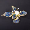 The Lorelei Lily Sculpted Resin Brooch - A lovely, long, elegant piece that features a five-petal lily clustered around a single pearl, with colourful resin to really make it pop and a dusting of crystal along the underside of the petals.