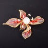 The Lorelei Lily Sculpted Resin Brooch - A lovely, long, elegant piece that features a five-petal lily clustered around a single pearl, with colourful resin to really make it pop and a dusting of crystal along the underside of the petals.