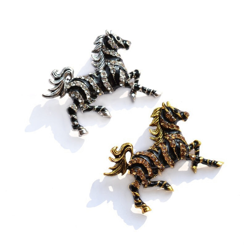Zesty Zebra Brooch - A medium sized brooch shaped like a zebra running with its mane and tail flowing in the wind. It's available in gold or silver colours, and is studded with crystals. 