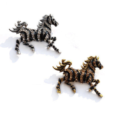 Zesty Zebra Brooch - A medium sized brooch shaped like a zebra running with its mane and tail flowing in the wind. It's available in gold or silver colours, and is studded with crystals.