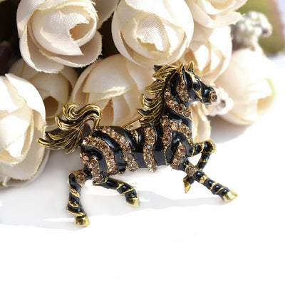 Zesty Zebra Brooch - A medium sized brooch shaped like a zebra running with its mane and tail flowing in the wind. It's available in gold or silver colours, and is studded with crystals.