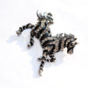 Zesty Zebra Brooch - A medium sized brooch shaped like a zebra running with its mane and tail flowing in the wind. It's available in gold or silver colours, and is studded with crystals.