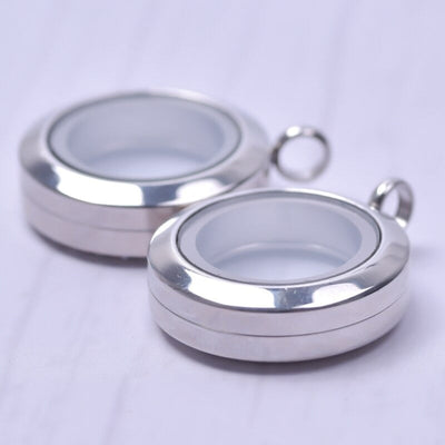 Mnemosyne Twist Floating Locket - A stainless steel locket with panels of glass front and back so that they contents of the locket can be seen from both sides.