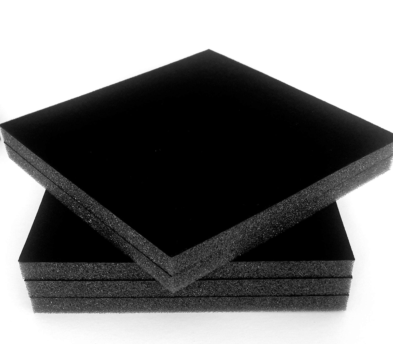 A stack of large sheets of velour flocked foam.