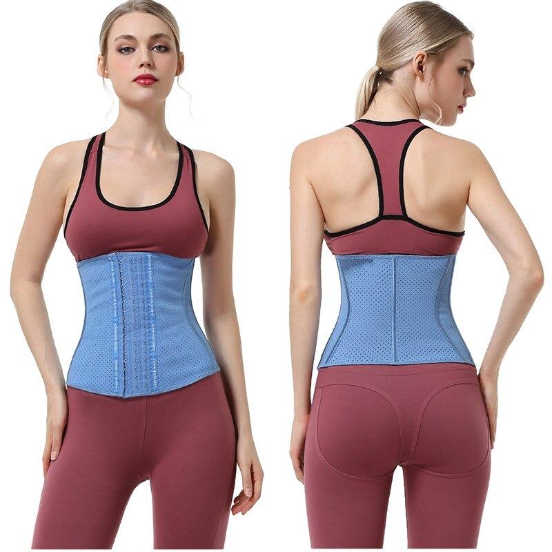 Artemis Vented Fitness Waist Trainer - This picture shows an athletic young woman wearing sportswear, and the waist trainer over top. The waist trainer has structured curved boning around the waist, and is made of vented latex. It is a cute baby blue colour. 