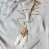 The Feathered Medallion - A long sweater chain adorned with feathers and faux pearls.