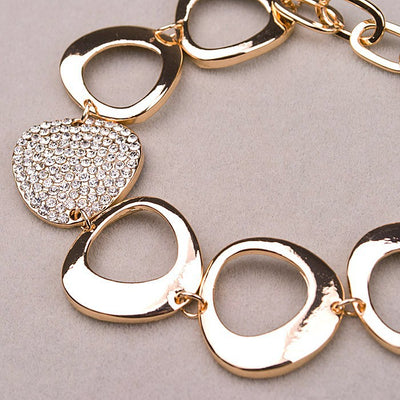 Reuleaux Link Bracelet - An unusual and elegant gold bracelet with large asymmetrical shapes and artificial crystals.