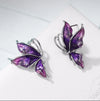 Vibrantly colourful enamel earrings with a butterfly motif, available in blue, green, purple, and red.