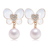 Flutterdrop Earrings - Small stud earrings with a butterfly and pearl motif.