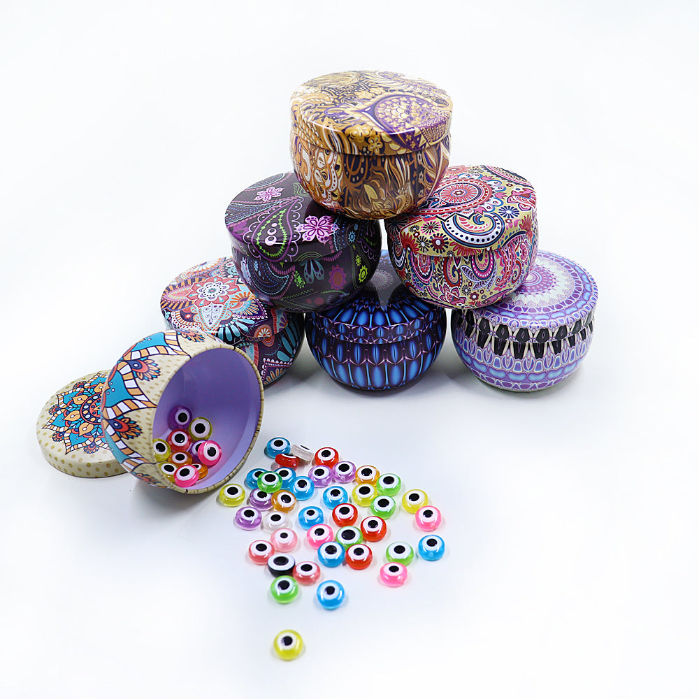 Cheeky Crafter Bountiful Bead Kits - Evil Eye - Small round plastic beads with an eye theme, available in an assortment of bright colours. Come stored in a cute metal tin with a retro themed print.